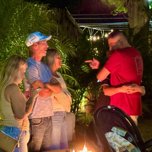 Friends gather around a fire pit at The Salted Rim Margarita Bar & Grille, enjoying the evening.