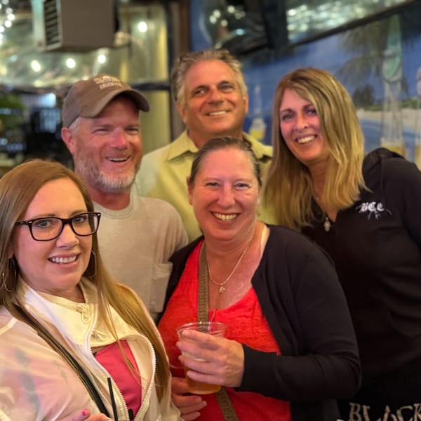 Five smiling friends, three women and two men, posing together at The Salted Rim Margarita Bar & Grille.