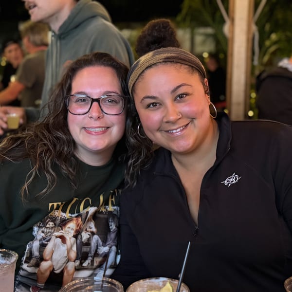 Two smiling women posing for a photo at The Salted Rim Margarita Bar & Grille.